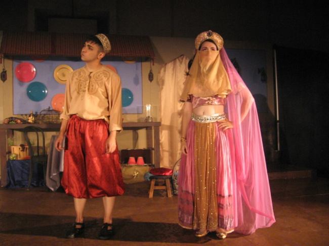 Aladdin (l- Sam Hayder) and Princess Opal (r- Amy Greco) encountering each other on the streets of Baghdad. 