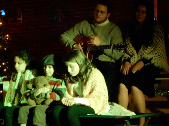 (l to r) The Cratchit Family- Hope (Emilee Schmidt) Tiny Tim (Sophia Nasreen Riazi-Sekowski) Joy (Samantha Roberts) Bob (Robert Scott) and Rachel (Melanie Pino-Elliott) 