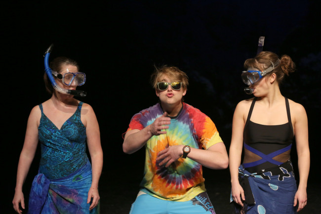 Susan (L- Marianne Angelella) and Sarah (R- Kathryn Zoerb) take snorkeling instructions from an Island Dude (C- Travis Hudson) on the beaches of Hawaii