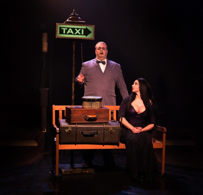 Lurch (L- David Bosley-Reynolds) waits calls Morticia (R- Priscilla Cuellar) a Taxi as she prepares to leave Gomez.