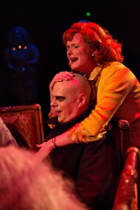 Uncle Fester (L- Shawn Kettering) is embraced by Alice Beineke (R- Elizabeth Rayca) during her full disclosure at dinner.