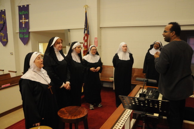 The Nuns rehearse for their talent show with Keyboardist Vince Evans (right) 