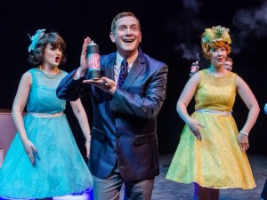 Jeremy Goldman (center) as Corny Collins singing the show's title song "It's Hairspray!"