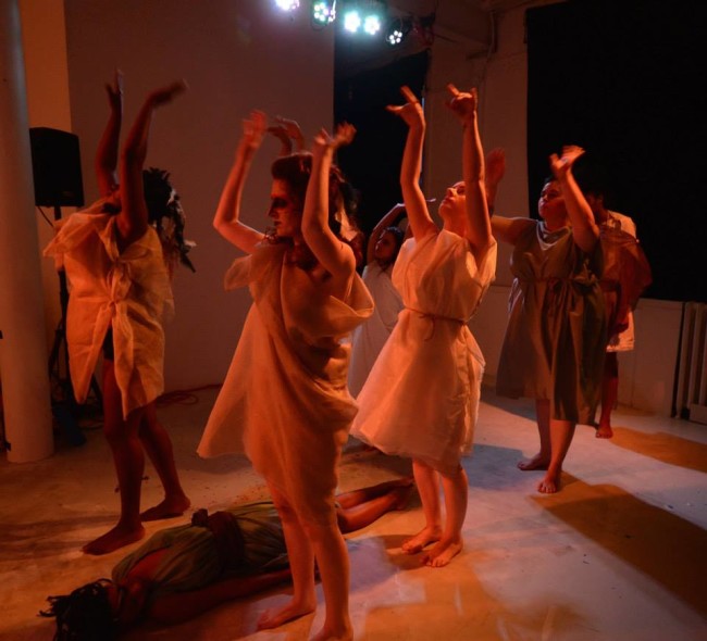 Iphigenia (Paris Brown, floor) and Agamemnon (Dana Woodson, back) while The Chorus (l-r, front to back Trustina Fafa Sabah, Sarah Weissman, Ren Pepitone, Katharine Vary, and Andrea Bush) recalls Agamemnon’s fateful trip to the woods