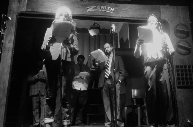 Emily Moore (left) as Irene Payton, Marty Day (center) as the unidentified creature, and Michael Stevenson (right) as press man Rob Becker reading The Incident at Red Belles Farms by Alfred Underhill