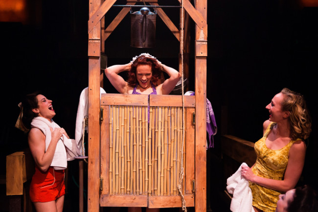 Teresa Dansky (center) as Ensign Nellie Forbush during "I'm Gonna Wash That Man Right Out of My Hair" in South Pacific at Toby's Dinner Theatre