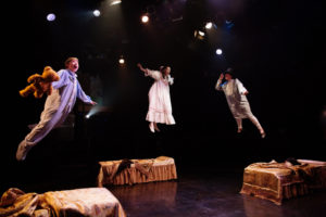 Gavin Willard (left) as Michael Darling, Katie Tyler (center) as Wendy Darling, and Brian Rusk (right) as John Darling flying through the nursery in Peter Pan