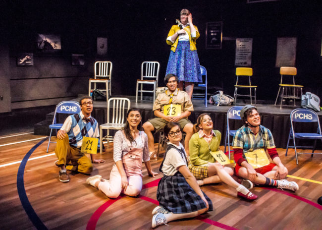 Lauren Blake Williams (back center) as Rona Lisa Peretti and The Spellers of The 25th Annual Putnam County Spelling Bee