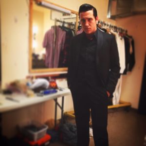 Austin Wayne Price preparing to take the stage as Johnny Cash in Million Dollar Quartet at Infinity Theatre Company