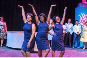 Renata Hammond (center) as a Dynamite in the 2015 summer production of Hairspray at Purple Light Theatre Company