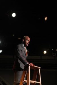 Ian Anthony Coleman as Caldwell B. Cladwell in Urinetown: The Musical