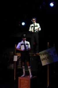 RJ Pavel (below) as Officer Barrell and Alan Naylor (above) as Officer Lockstock in Urinetown: The Musical