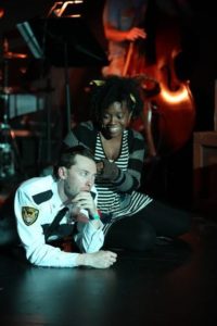 Alan Naylor (left) as Officer Lockstock and Sakile Lyles (right) as Little Sally in Urinetown: The Musical