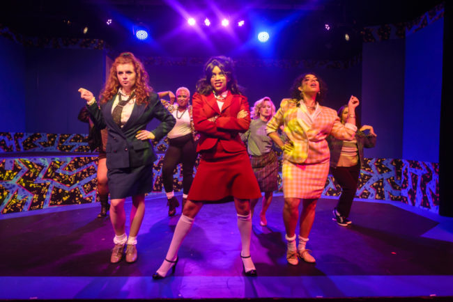 Megan Bunn (left) as Heather Duke, Tiara Whaley (center) as Heather Chandler, and Geocel Batista (right) as Heather McNamara in Heathers The Musical