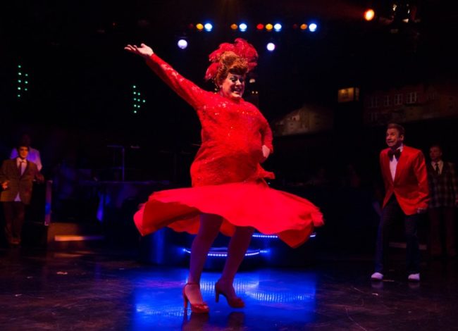 Larry Munsey (left) as Edna Turnblad performing the big finish in "You Cant Stop the Beat" while David James (right) as Wilbur Turnblad watches