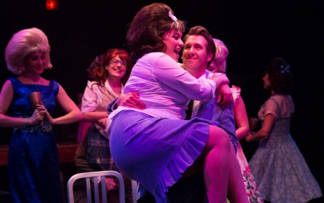 Christie Graham (foreground left) as Tracy and Justin Calhoun (foreground right) as Link with Heather Marie Beck (background left) as Velma Von Tussle and Sohpie Schulman (background center) as Penny in Hairspray