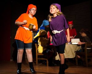 Doc (Maggie Walker) and Dopey (Ruby McKerrow), background: Sneezy (Veronica King), Bashful (Amenah Kitchens), Happy (Molly Ross), Grumpy (London Leyda)