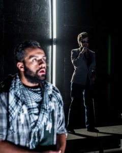 Ahmad Kamal (foreground) as Amor and Nora Achrati (background) as Supervisor in I Call My Brothers at Forum Theatre