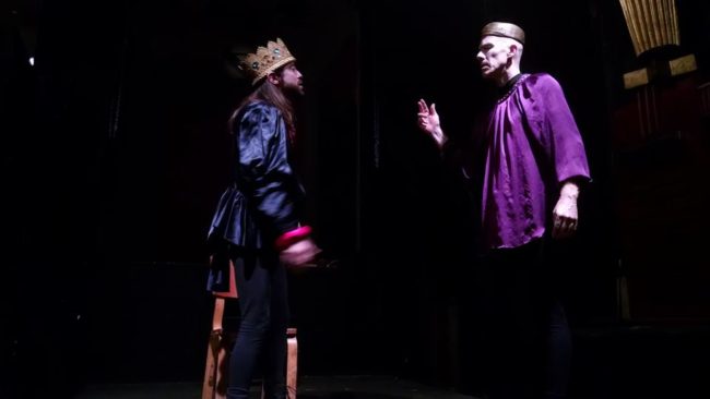 Junius Brutus Booth (L- Scott Burke) as Richard III on the battlefield with Flynn (R- Alex Hacker) informing him of news of Richmond in "His Majestic Lump of Foul Deformity"