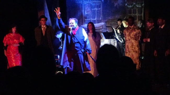 Andrew Lloyd Baughman (center) as John Jasper singing "Jasper's Confession" in The Mystery of Edwin Drood