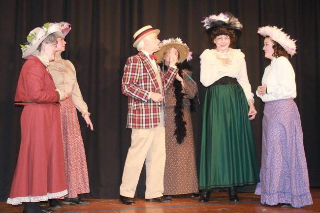 Michael Hulett (center) as Harold Hill and the ladies of River City in Music Man