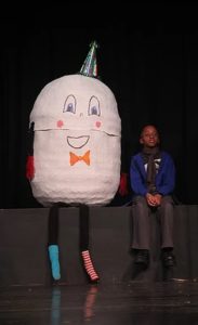 Linwood Scott (right) sits with Humpty Dumpty (left) and watches "The March of the Toys" 