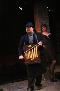 Connor Moore as The Street Singer in The Three Penny Opera