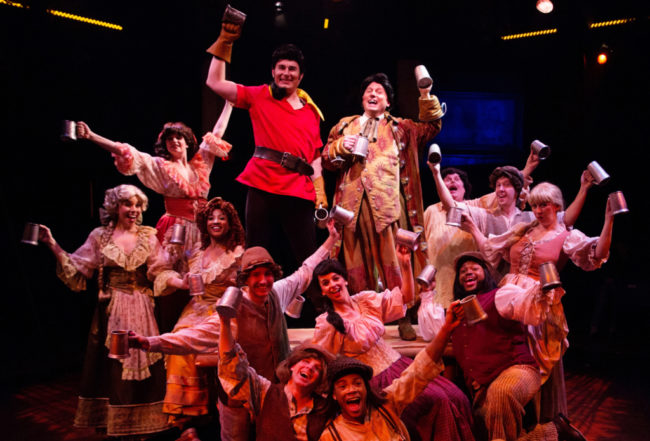 David Jennings (center left) as Gaston and Jeffery Shankle (center right) as Lefou and the ensemble in Beauty & The Beast