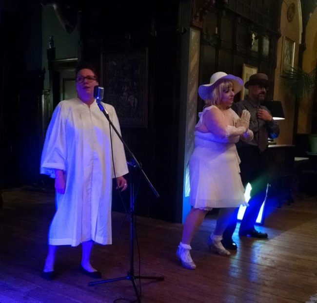 Reverend Joy Ryde (left) with Tapitha Kix (center) and Brother Covington (right) performing "Day by Day" accompanied by (not pictured) Organist Reverend Robin Byrd