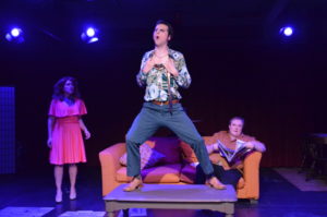 Lee Conderacci (left) as Avril, Matthew Lindsay Payne (center) as George and Zack Johnson (on couch) as Tony in Voices in the Rubble