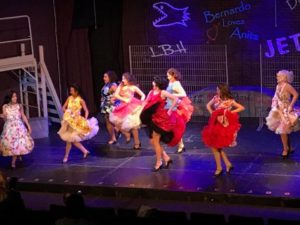 Rachel Miler (center, red dress) as Anita and the Shark Girls in "America" 