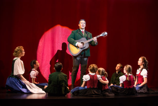 Charlotte Maltby (left) as Maria and Nicholas Rodriguez (center) as Captain Georg von Trapp and the von Trapp children