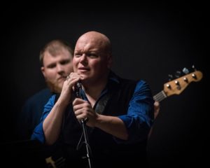 Lance Bankerd (foreground) as King <Claudius> and Brett Pearson (background) on bass