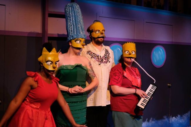 (L to R) Christine Wells as Lisa Simpson, Hannah Fogler as Marge Simpson, Jonathan Jacobs as Homer Simpson, and Meghan Stanton as Bart Simpson in the Act III of Mr. Burns: A Post-Electric Play at Cohesion Theatre Company