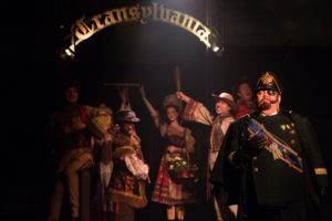 David Bosley-Reynolds (right) as Inspector Kemp and the Villagers of Transylvania 