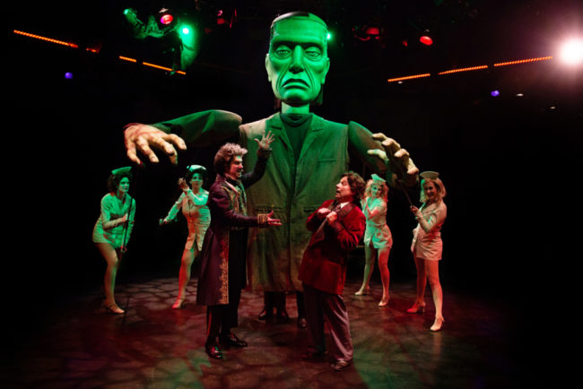 Justin Calhoun (center left) as Victor Frankenstein with Jeffrey Shankle (center right) as Dr. Frederick Frankenstein and the Lab Babes