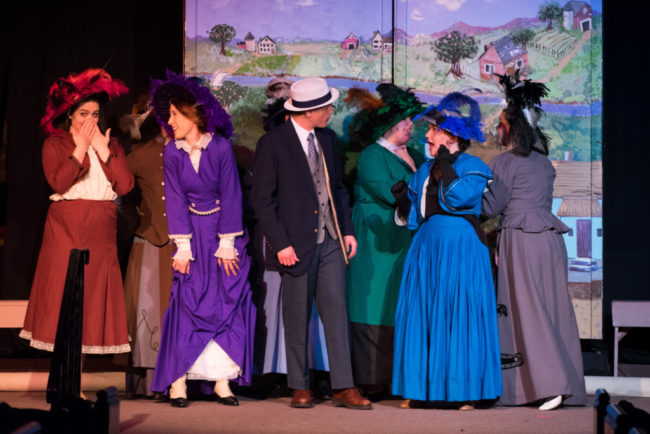 Joe Weinhoffer (center) as Harold Hill and the Ladies of River City, Iowa