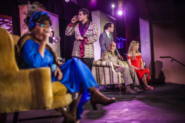 (L to R) Michele Guyton as Mrs. Peacock, Eric Brooks as Mr. Boddy, Phil Hnasel as Colonel Mustard, Chris Volker as Mr. Green, and Denise Roger Mylin as Miss Scarlet