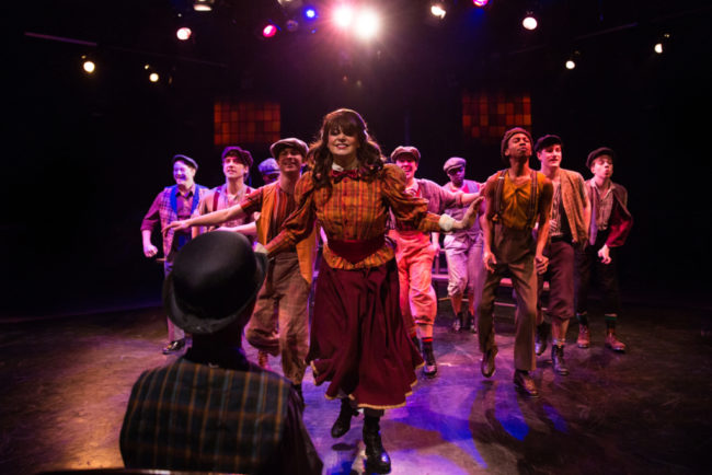 MaryKate Brouillet (center) as Katherine Plumber and The Newsies 