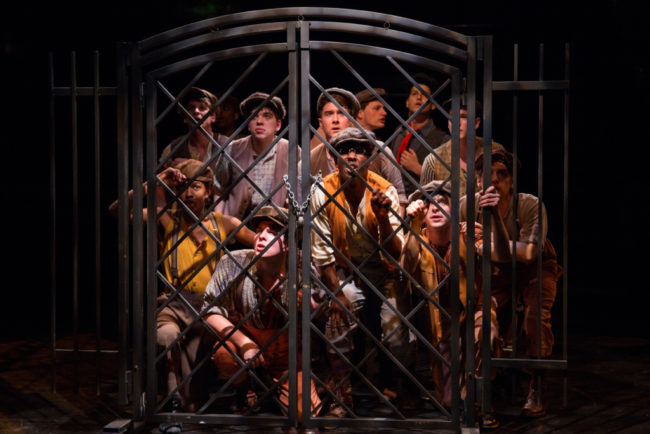 Newsies at the gates of The World in Newsies at Toby's Dinner Theatre