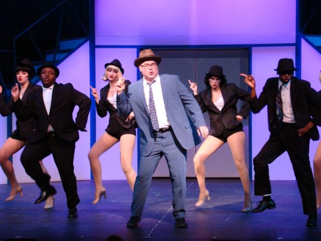 Steve Antonesen (center) as Carl Hanratty and the ensemble of Catch Me If You Can