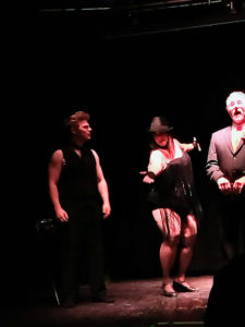 Scruffy Westside (left) with Tapitha Kix (center) and Dirk Hamfist (right) as Billy Flynn