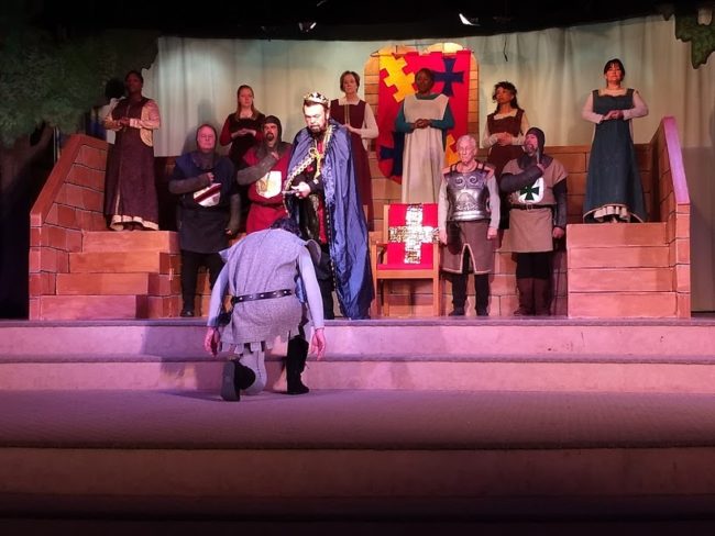 Chuck Dick (center) as King Arthur knights the kneeling Jim Gafferty (center below) as Sir Lancelot