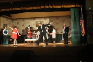 (L to R) Lauren DeSha as Grace Farrell, Mia Novak as Annie, Dough Kotula as Oliver Warbucks, and Forest Deal as Drake