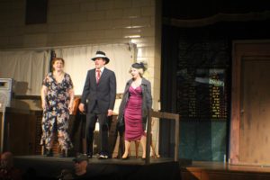 Heidi Toll (left) as Miss Hannigan, John Andrew Gurtshaw (center) as Rooster, and Ashley Case (right) as Lily St. Regis