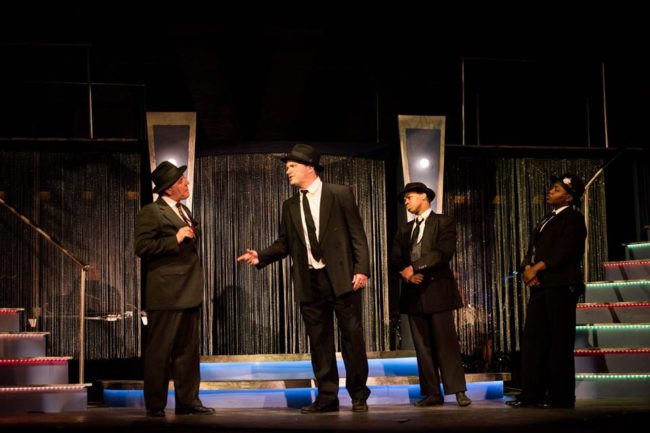 Jerry Vess (left) as Nick Valenti and Jeffrey Hawkins (center) as Cheech discuss a "contract" in Bullets Over Broadway at Annapolis Summer Garden Theatre