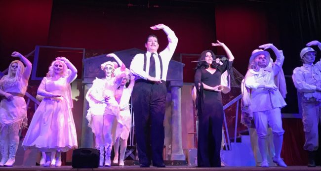 Vincent Musgrave (center left) as Gomez Addams and Santina Maiolatesi (center right) as Morticica Addams with the Addams Ancestors