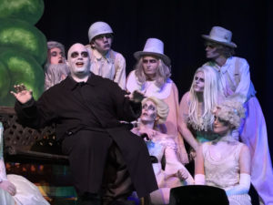 Michael Crook as Uncle Fester, and Addams Ancestors (L to R) Matt Sorak, Justin Moe, Atticus Boidy, Beth Cohen, Parker Bailey Steven, Billy Luzier, and Abby McDonough