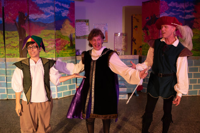 Mel Tillery (left) as Jester, Emma Hawthorn (center) as King Sextimus, and James Fitzpatrick (right) as Minstrel