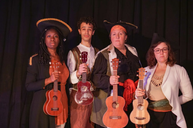(L to R) Tosi Olufolabi as Captain Smollett, Alex Turner as Jim Hawkins, Wyckham Avery as Long John Silver, and Paige O'Malley as Dr. Livsey in Treasure Island at We Happy Few.